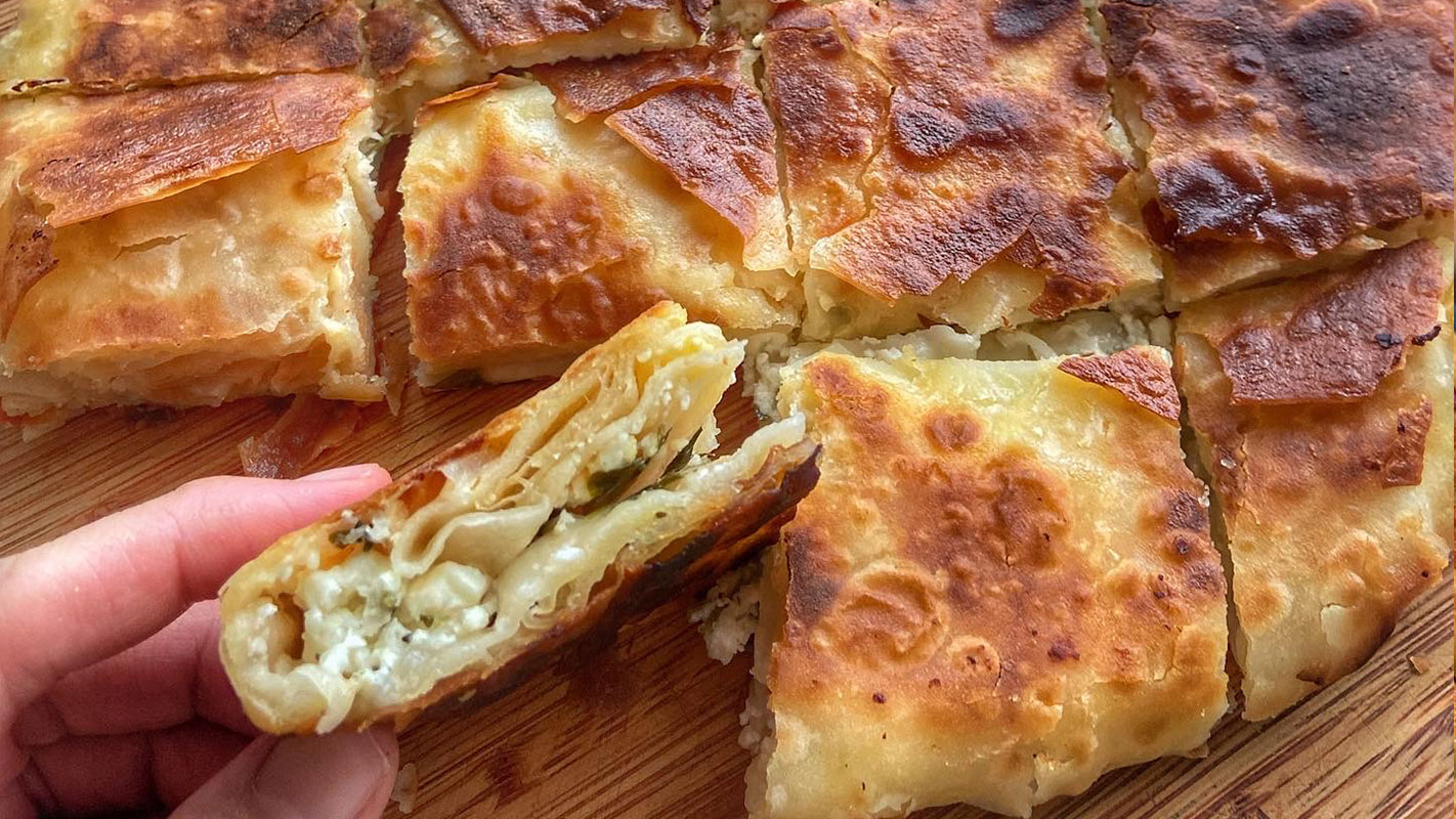 Traditional börek recipe with golden-brown phyllo dough and sesame seeds